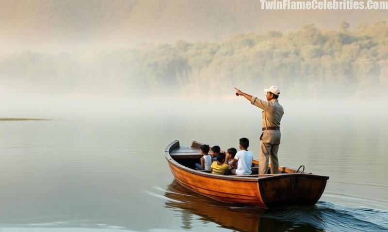 A group of children with their guide on a peaceful boating experience on Periyar Lake