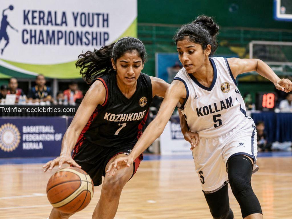 Two female basketball players from Kozhikode and Kollam competing for the ball during Kerala Youth Championship