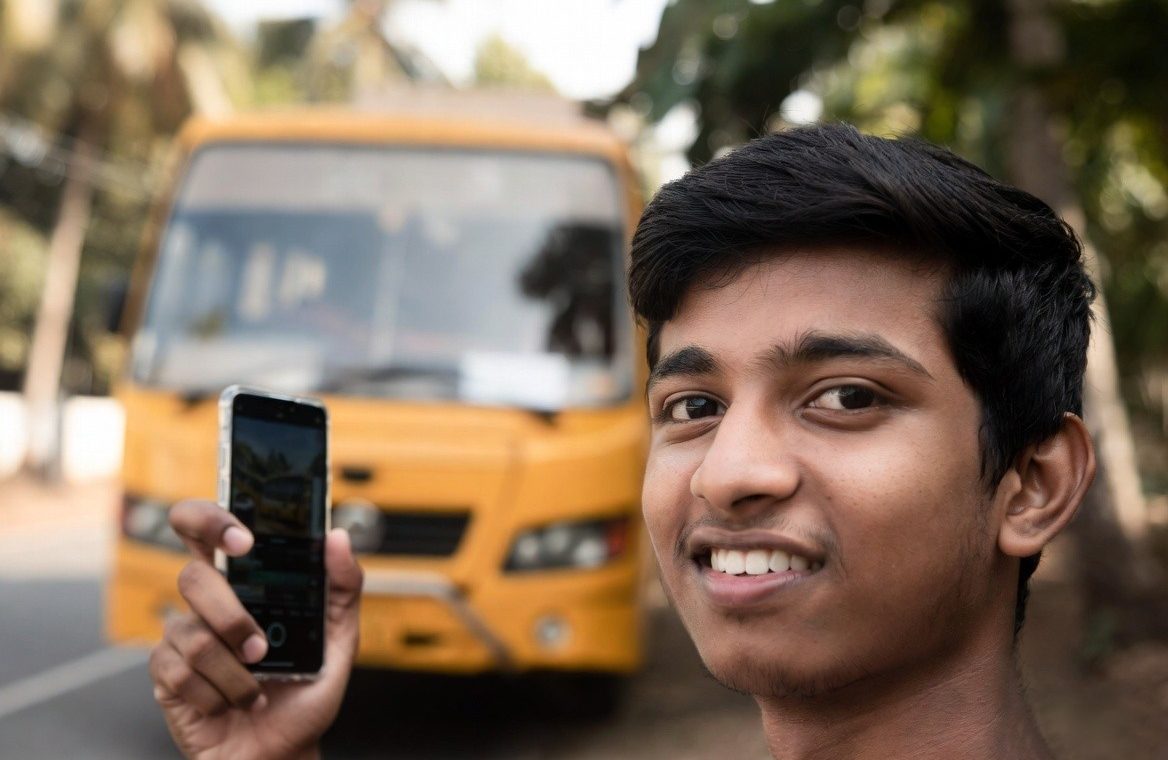 College student in Ernakulam waiting for a secure school bus.