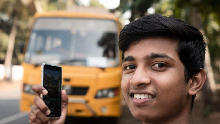 College student in Ernakulam waiting for a secure school bus.