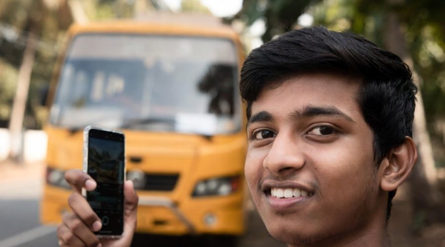 College student in Ernakulam waiting for a secure school bus.